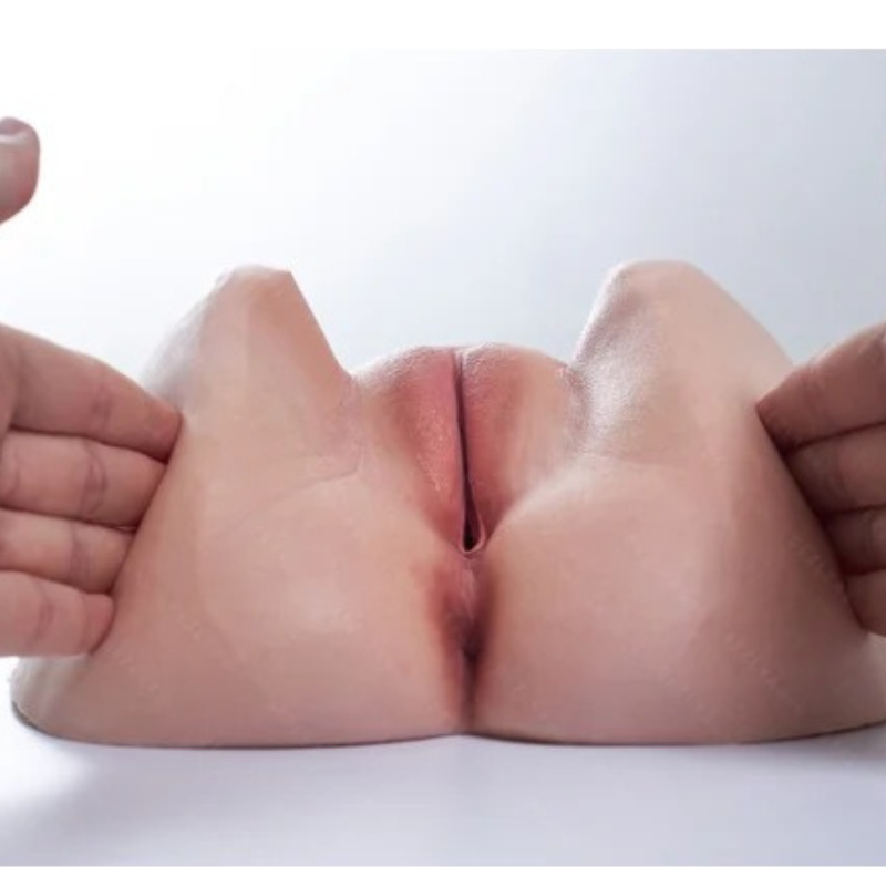 Realistic flesh-toned male masturbator with detailed labia and soft silicone texture held gently by hands