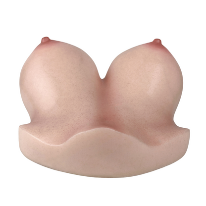 Realistic female breast-shaped masturbator with soft skin texture and natural pink tones