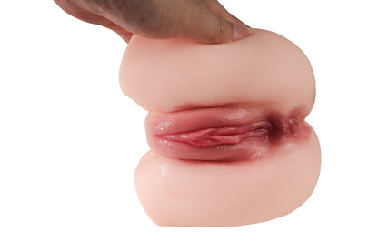 Hand holding realistic flesh-toned male masturbator with detailed vaginal canal and soft silicone texture
