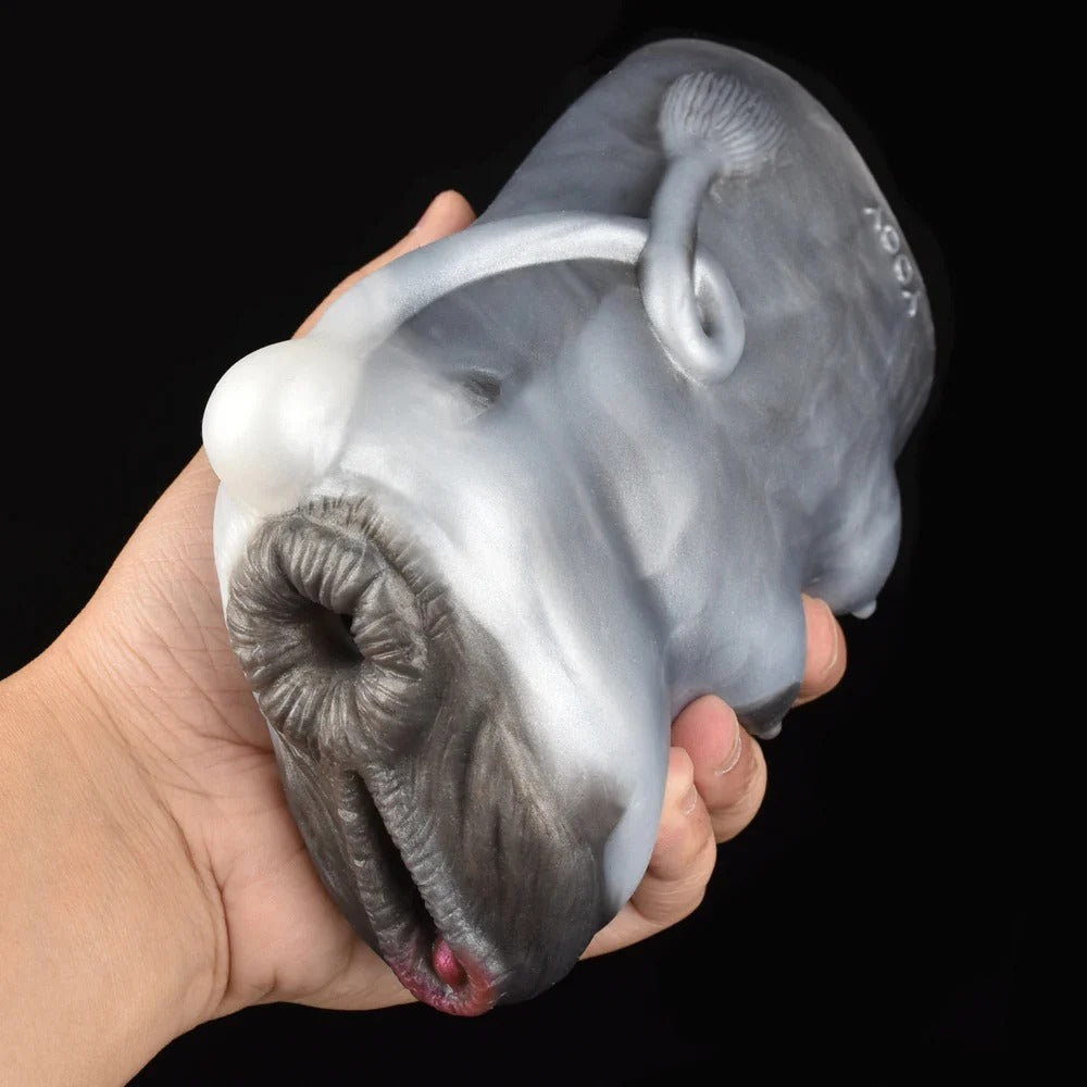 Realistic male masturbator with detailed labia, clitoral hood, and textured inner canal in soft gray silicone.