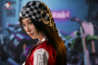 Realistic doll with long dark hair, wearing checkered beanie and red jacket, styled with nose and lip piercings.