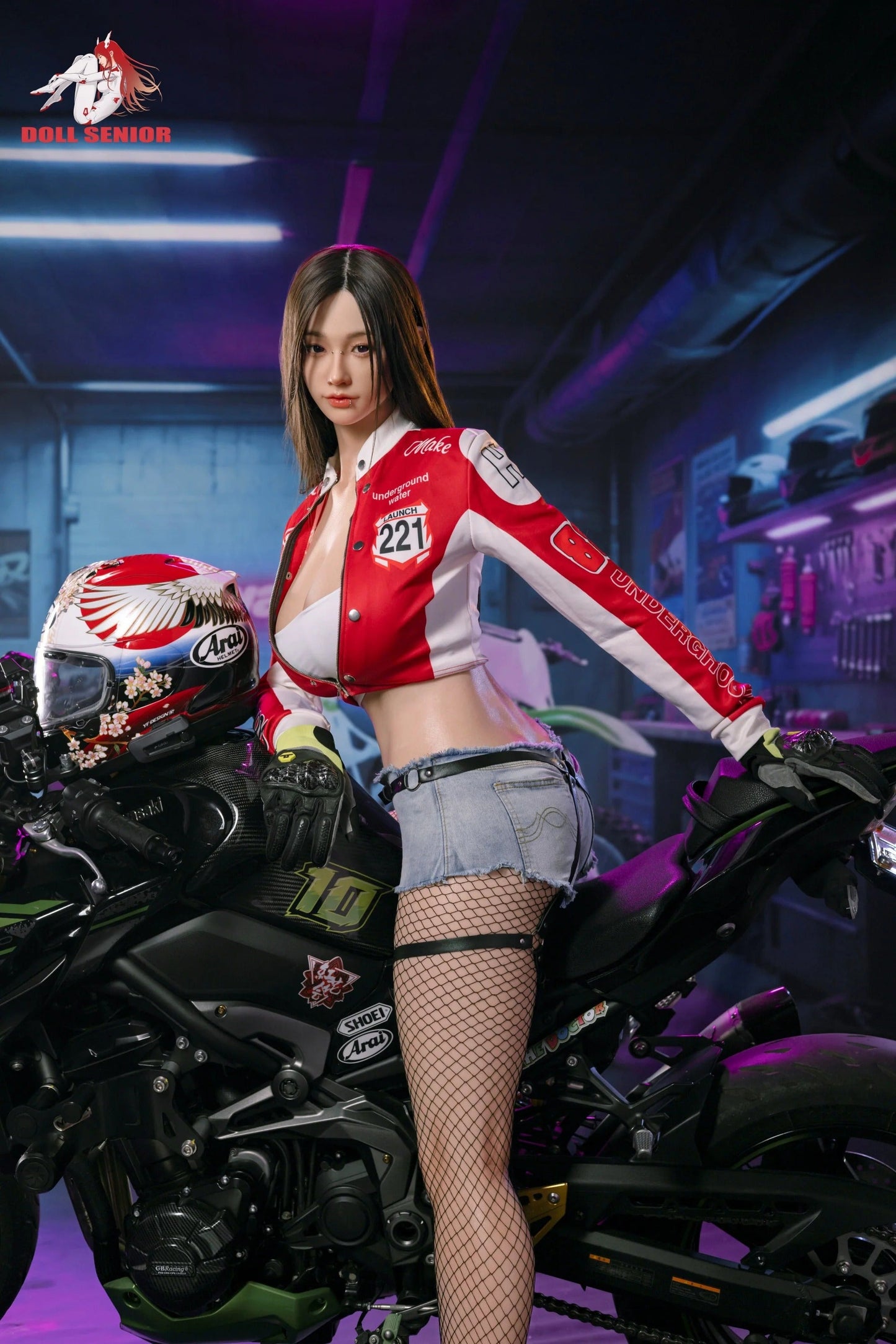 Realistic female doll in red racing jacket and denim shorts posing beside black motorcycle in neon-lit garage