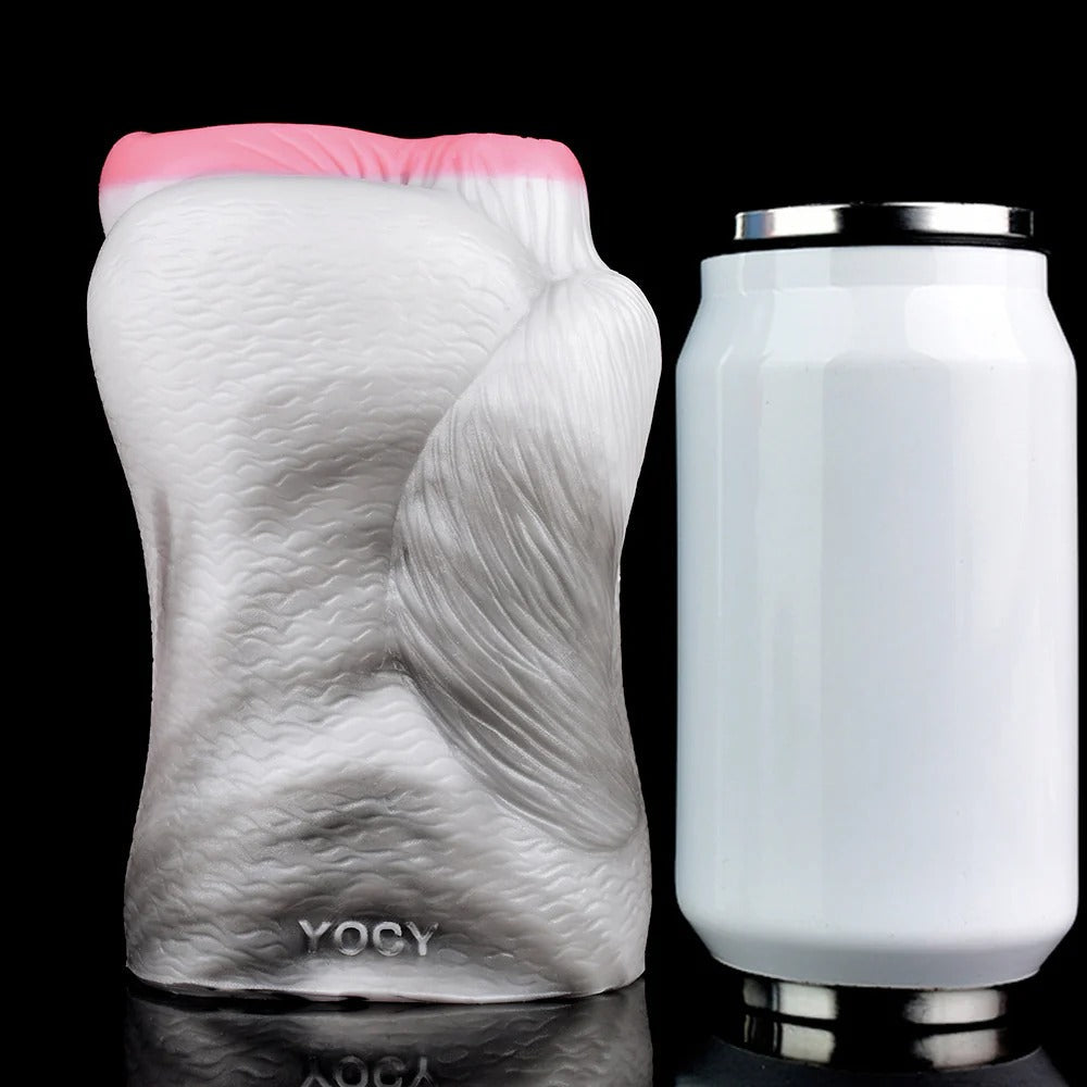 Realistic male masturbator with textured white body, pink opening, and YOCY branding, shown beside a can for scale