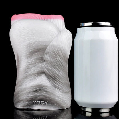 Realistic male masturbator with textured white body, pink opening, and YOCY branding, shown beside a can for scale