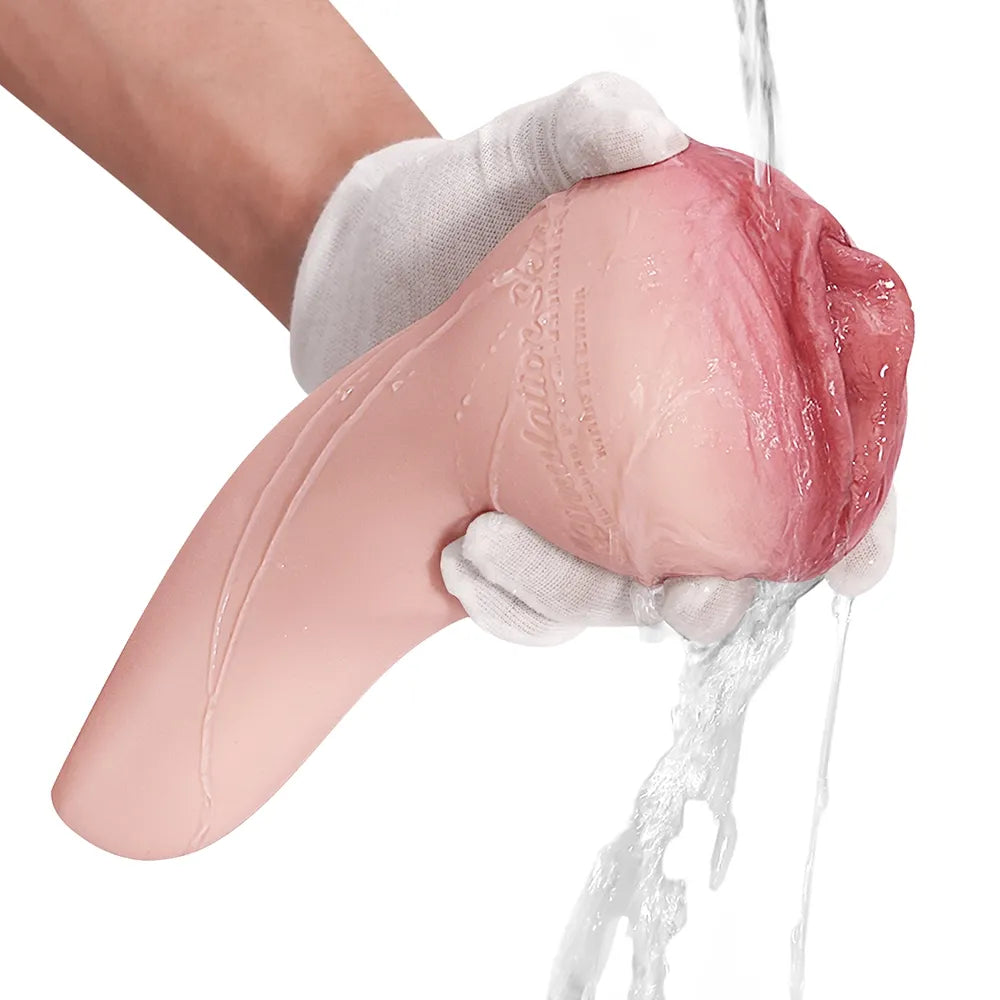 Realistic pink silicone male masturbator being rinsed under water, showing soft texture and anatomical details