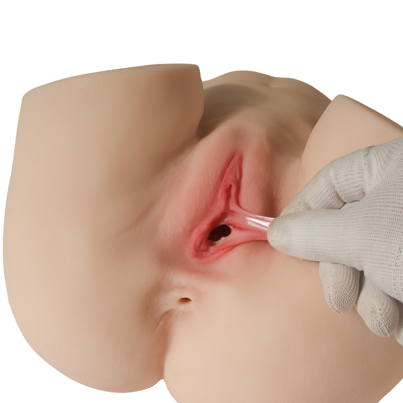 Realistic silicone male masturbator with detailed labia and vaginal canal, shown with gloved hand for scale