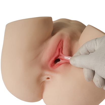 Realistic silicone male masturbator with detailed labia and vaginal canal, shown with gloved hand for scale