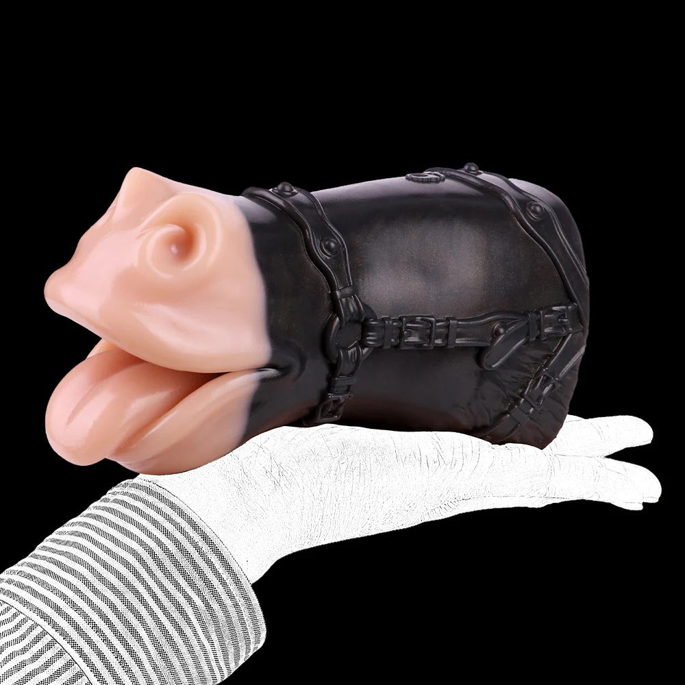 Realistic flesh-toned oral stimulator with black harness, held in gloved hand against dark background