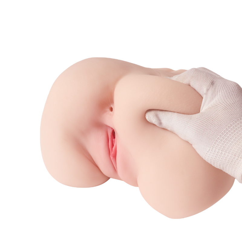 Realistic flesh-toned male masturbator with detailed labia and soft texture, shown with gloved hand for scale