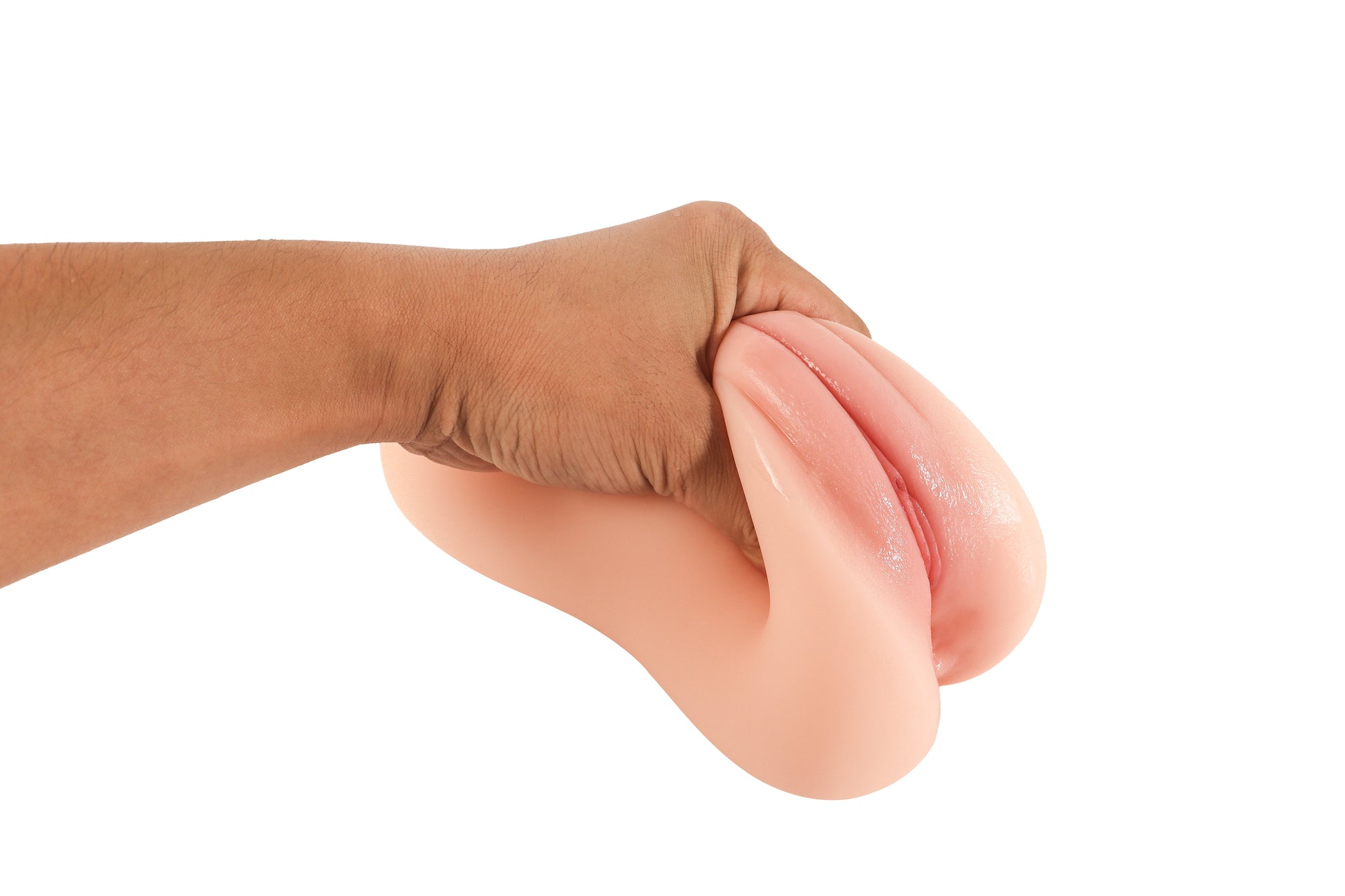 Hand squeezing realistic flesh-toned male masturbator with soft, textured surface and natural contours